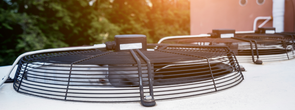 Close-up of industrial HVAC system cooling fans, highlighting air conditioning maintenance, energy efficiency, and temperature regulation in commercial buildings. Image emphasizes the importance of regular HVAC upkeep for optimal performance.